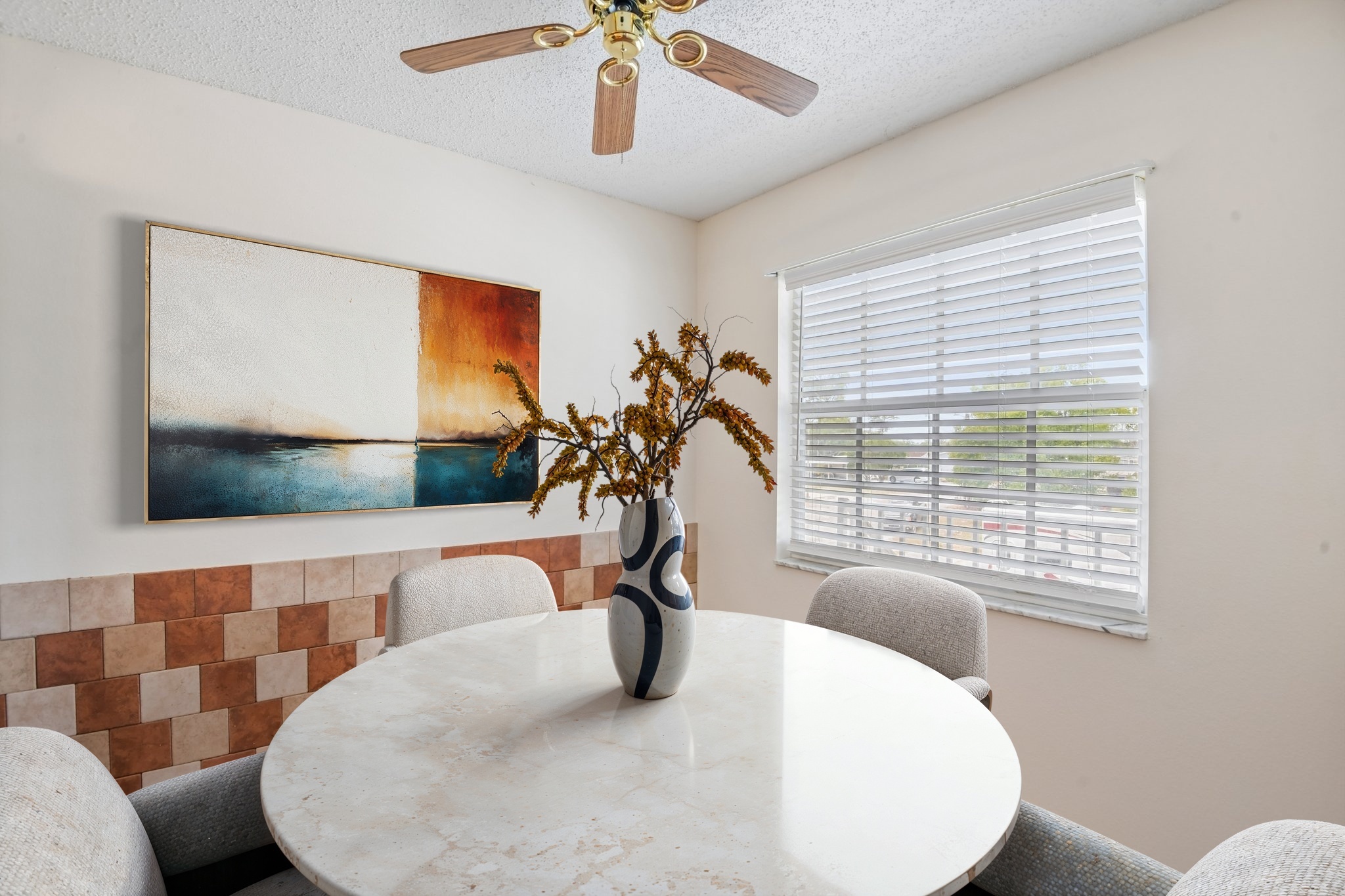 Eat-in kitchen dinette with decorative tile backsplash in this Hudson FL 55+ condo for sale