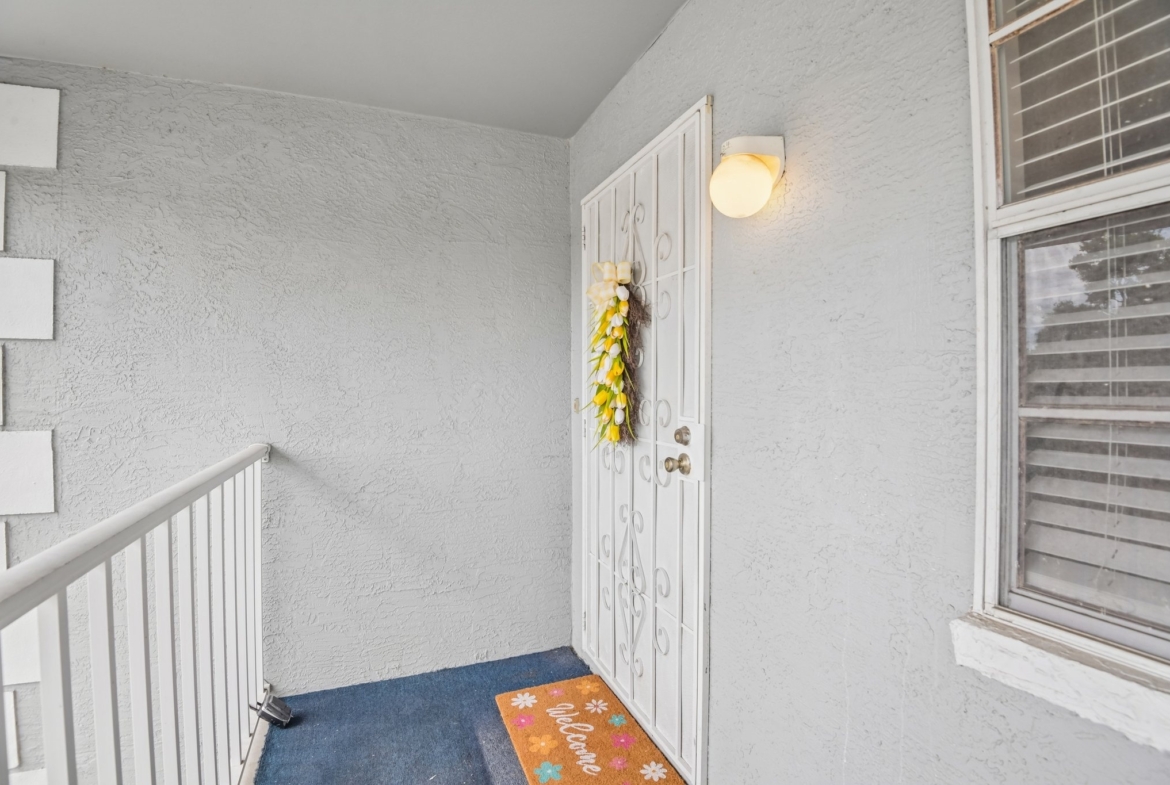 Private entry and stairwell to this second-floor condo at 7713 Hillside Ct #204, Hudson FL