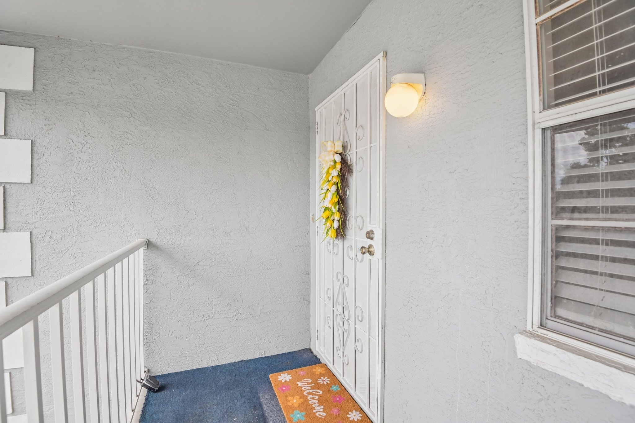 Private entry and stairwell to this second-floor condo at 7713 Hillside Ct #204, Hudson FL