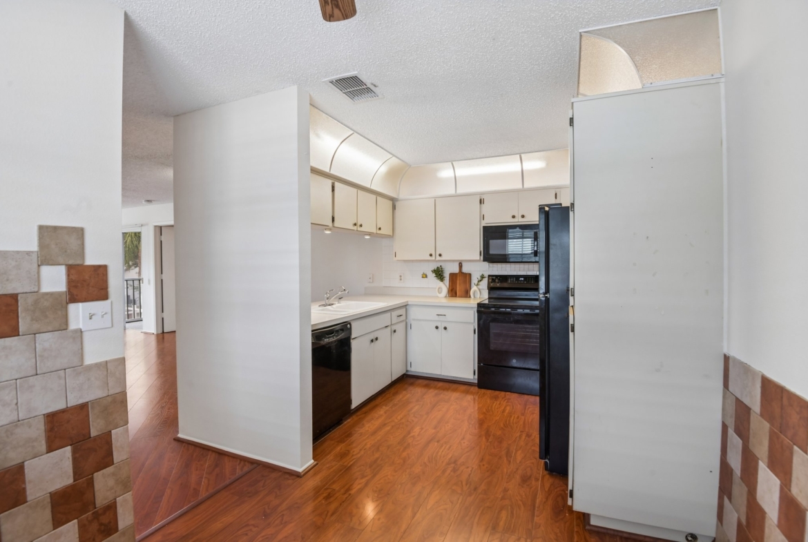 Eat-in kitchen viewed from the dining area in this move-in ready Hudson FL condo
