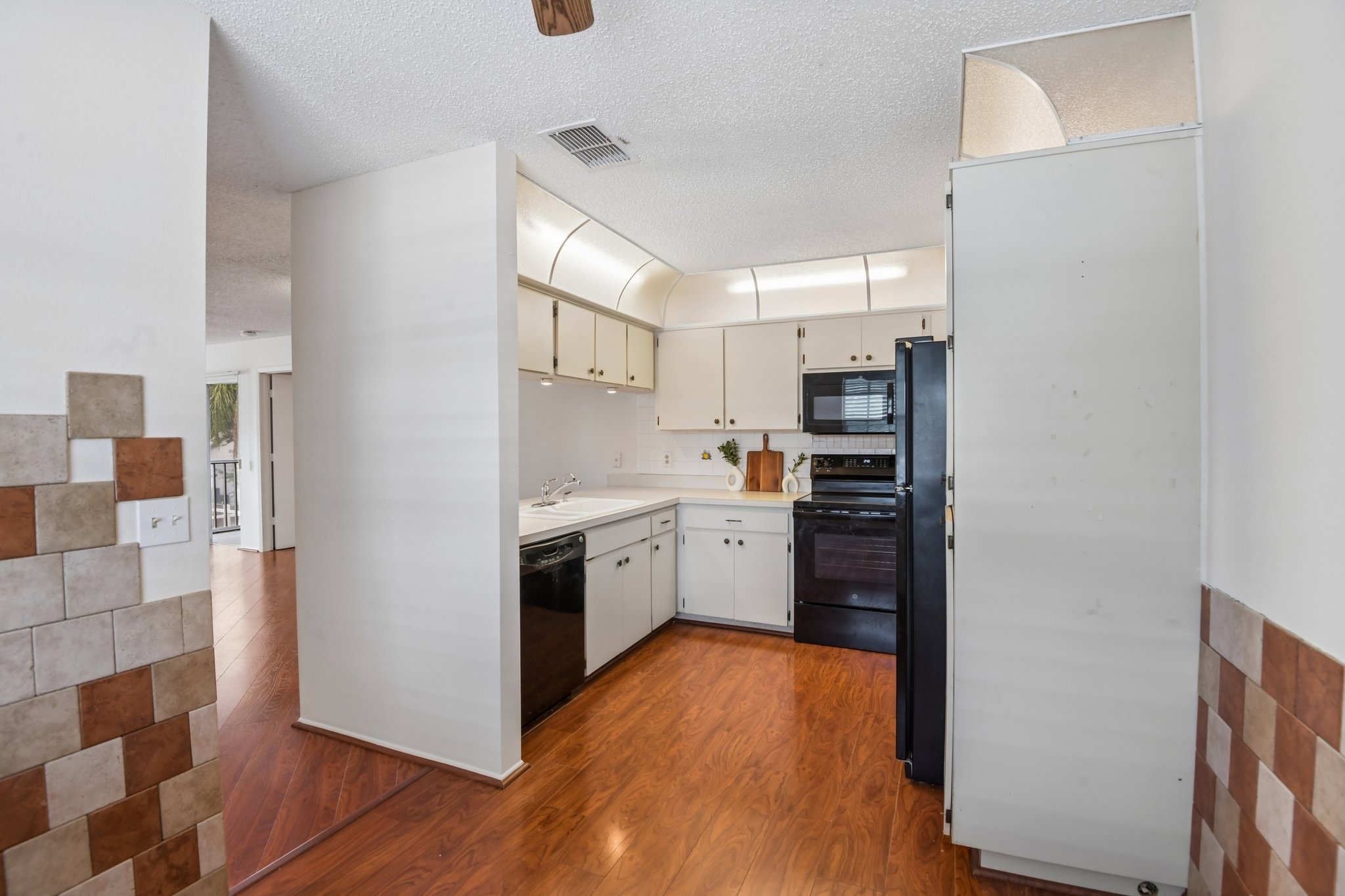 Eat-in kitchen viewed from the dining area in this move-in ready Hudson FL condo