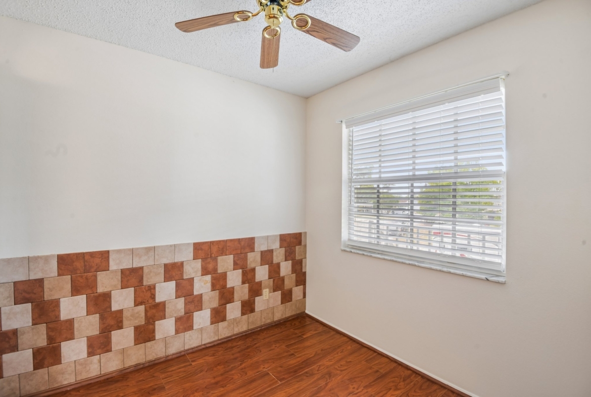 Kitchen dinette with tile accent wall at 7713 Hillside Ct #204, Hudson, FL 34667