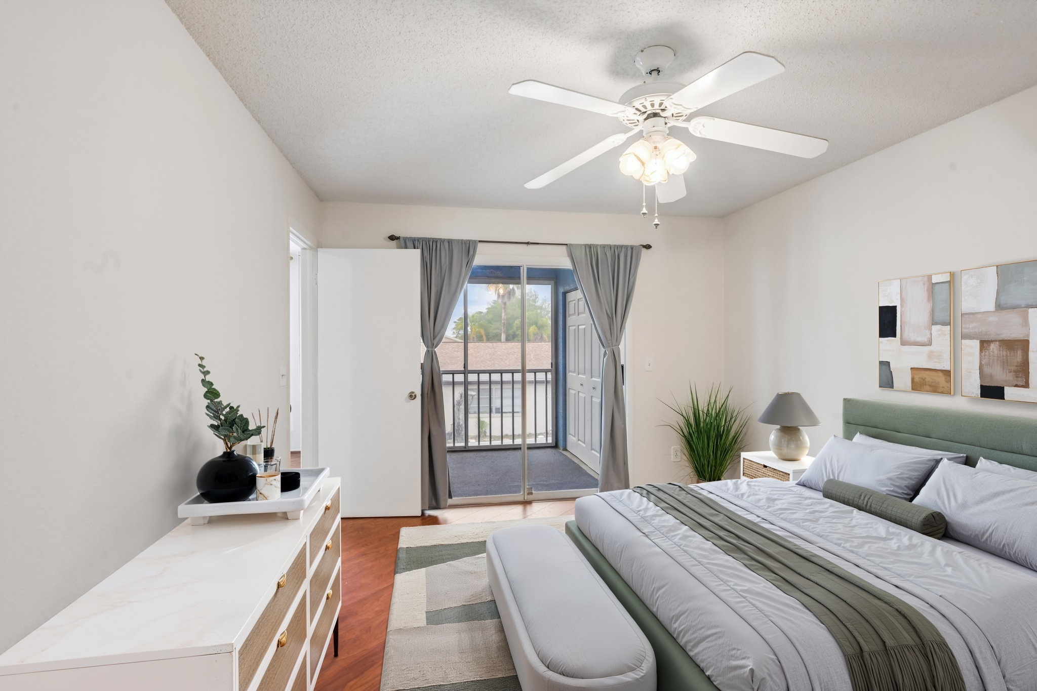 Virtually staged primary bedroom with balcony access at 7713 Hillside Ct #204, Hudson FL 34667