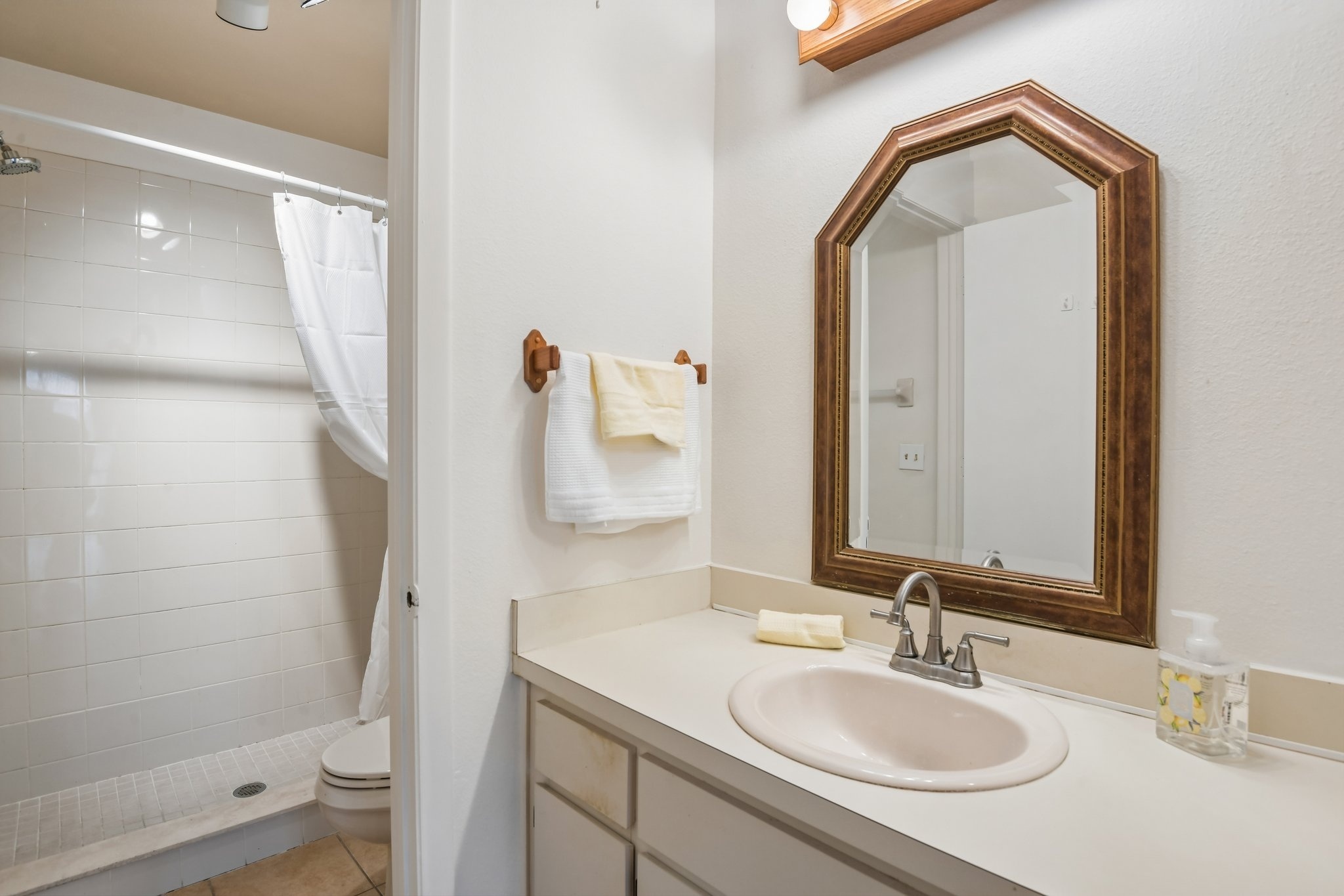 Primary bathroom vanity and mirror at 7713 Hillside Ct #204, Hudson FL