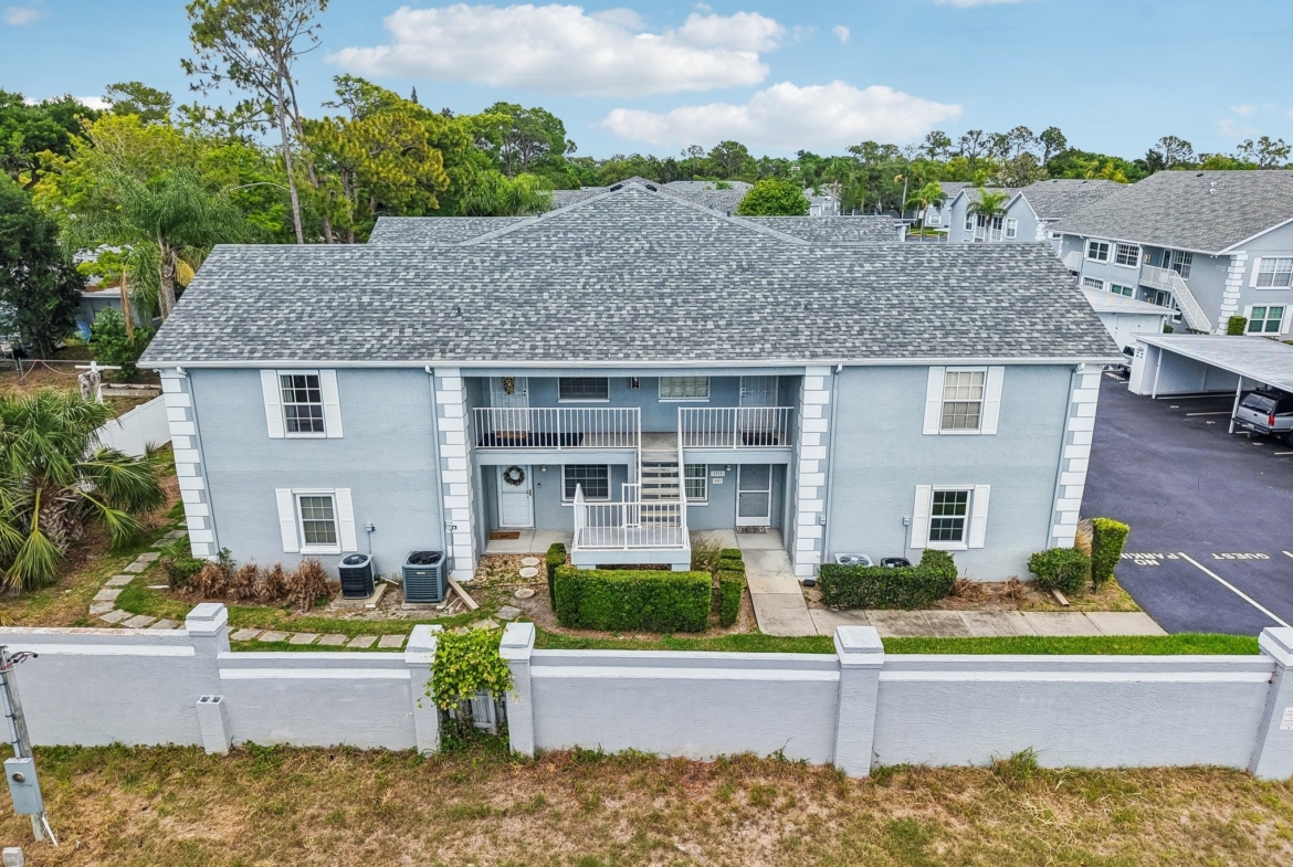 Side view of the condo building with carport parking at The Hillside, Hudson FL