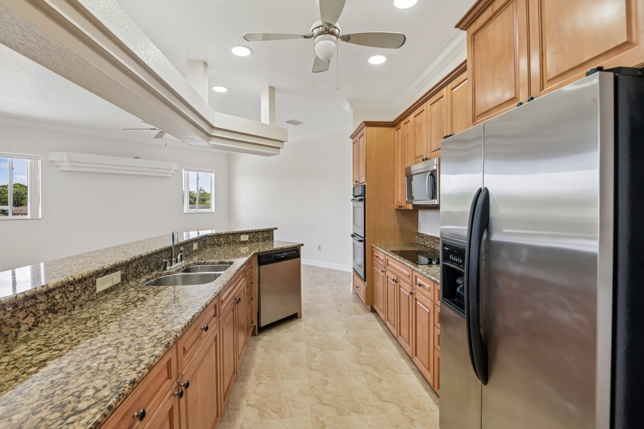 Gourmet kitchen with maple cabinetry, granite countertops and stainless appliances in Seminole FL 33777