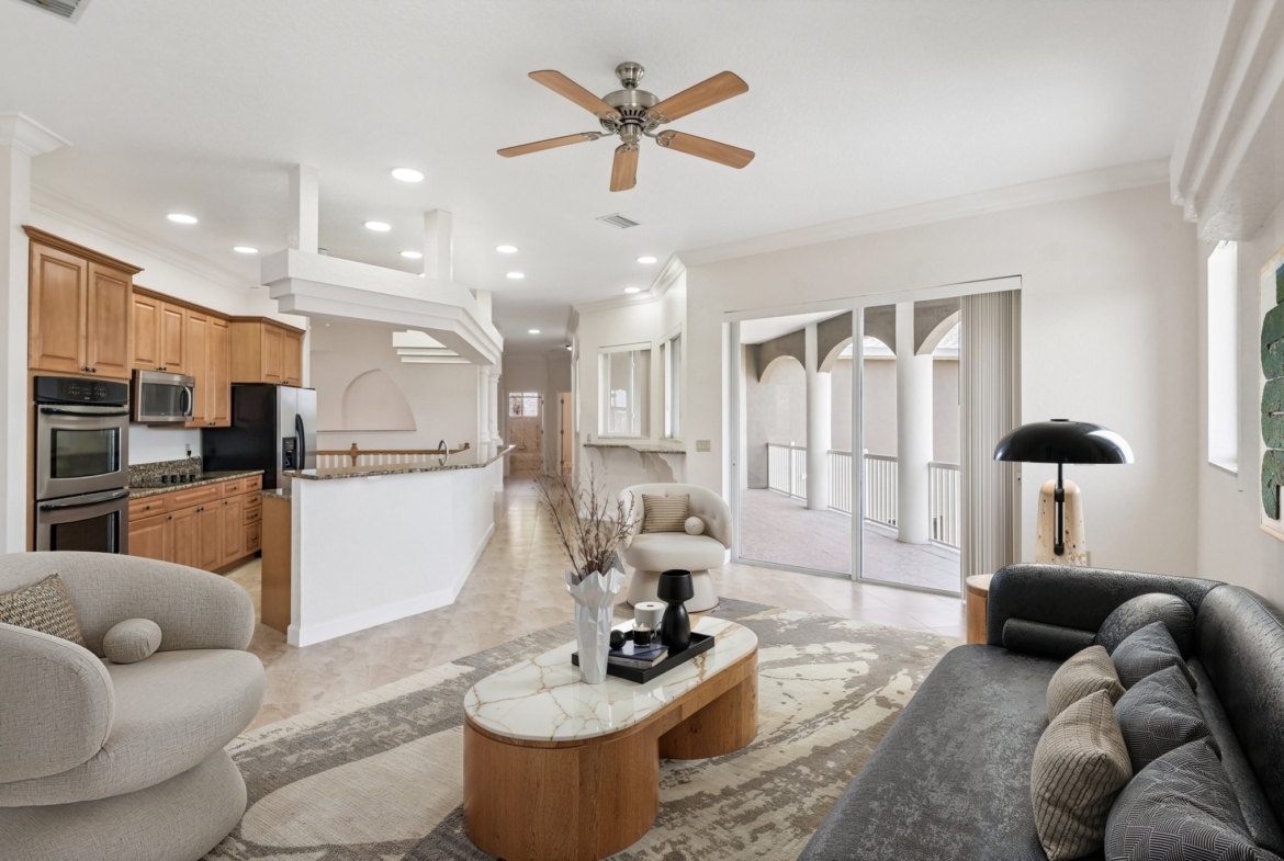Living room with ceiling fan and sliders to the balcony overlooking the canal, Seminole FL