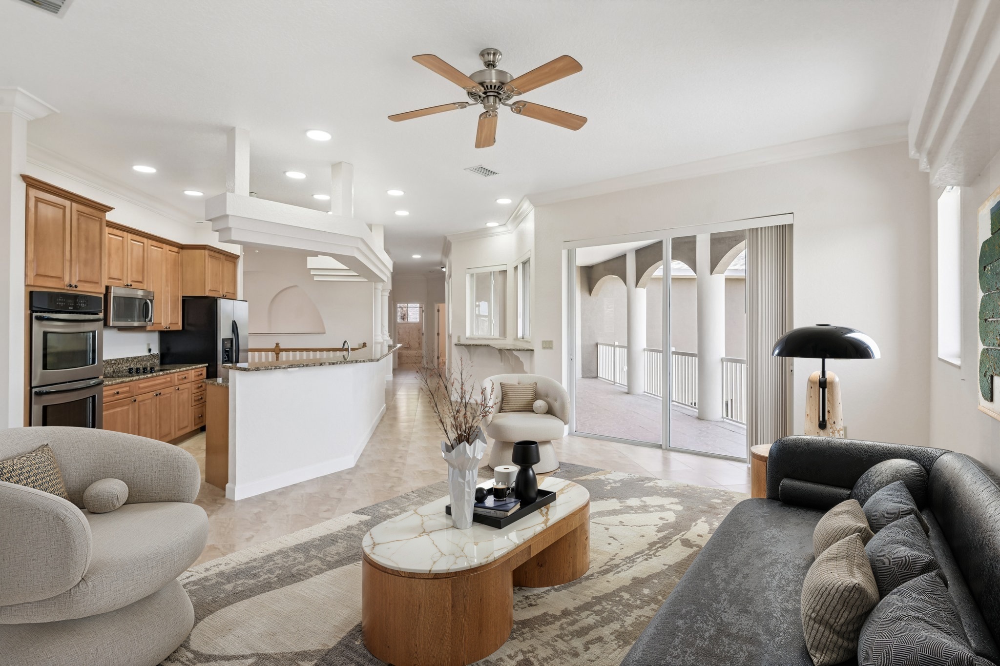 Living room with ceiling fan and sliders to the balcony overlooking the canal, Seminole FL