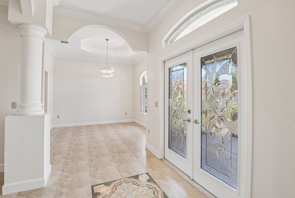 Entry hall with soaring arched windows and high ceilings in this custom Seminole FL estate