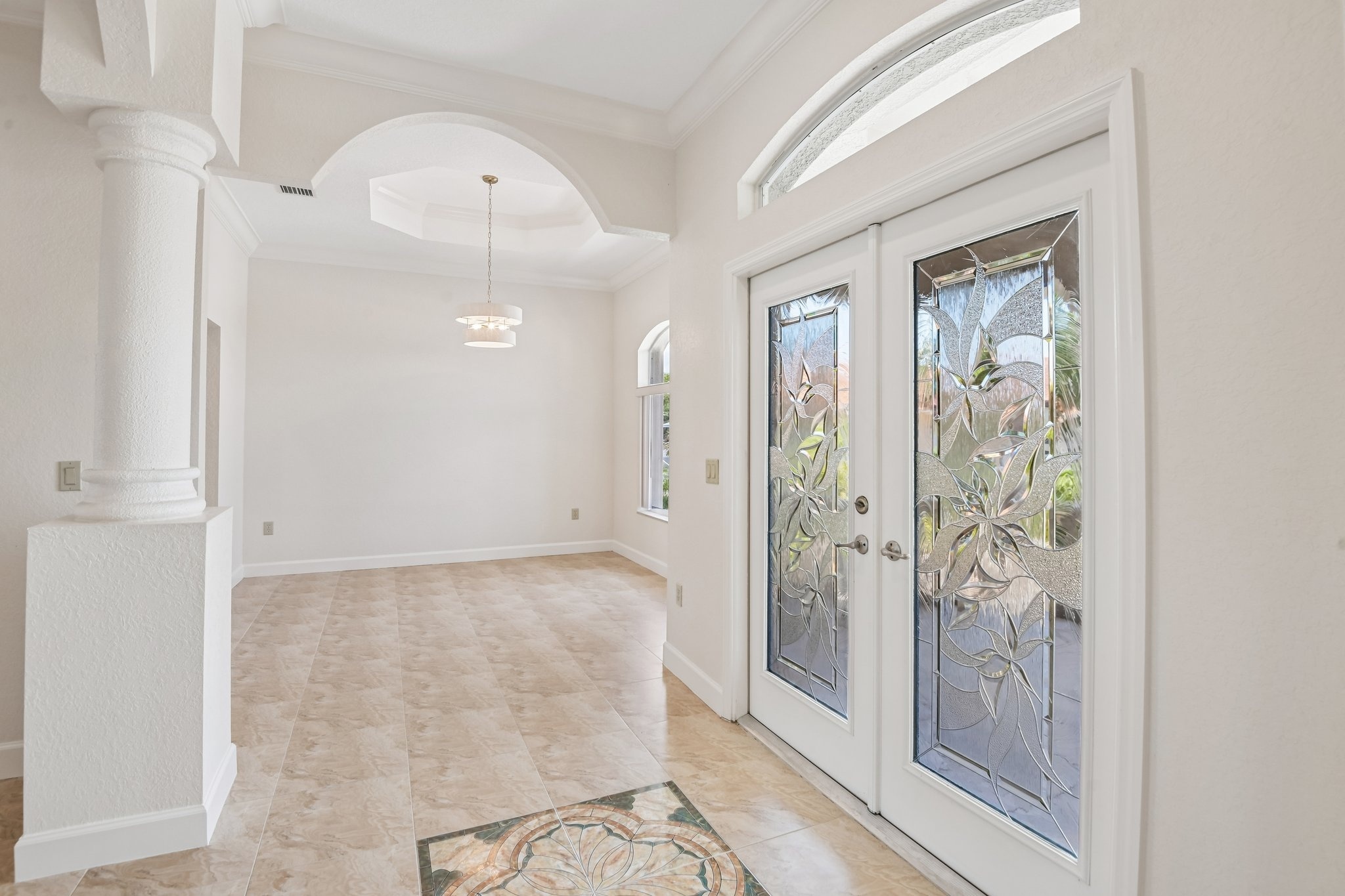 Entry hall with soaring arched windows and high ceilings in this custom Seminole FL estate
