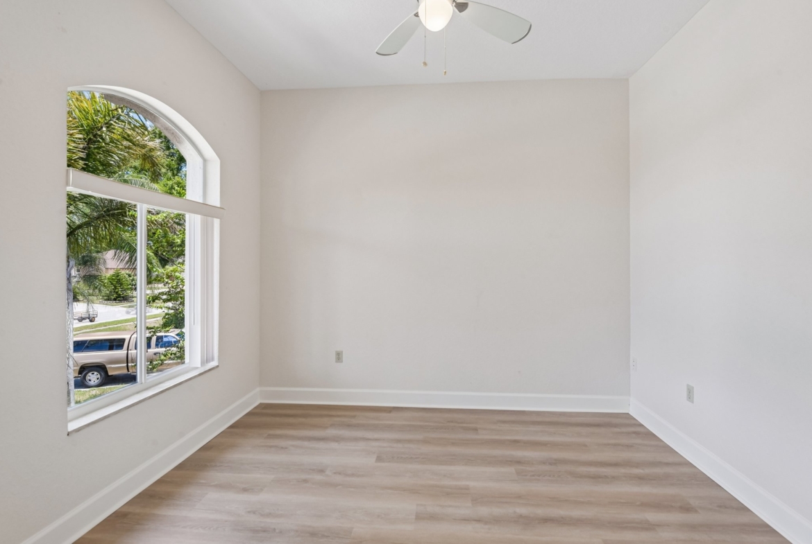Bright flex room with arched window and laminate flooring at 8335 Cheyenne Dr, Seminole FL