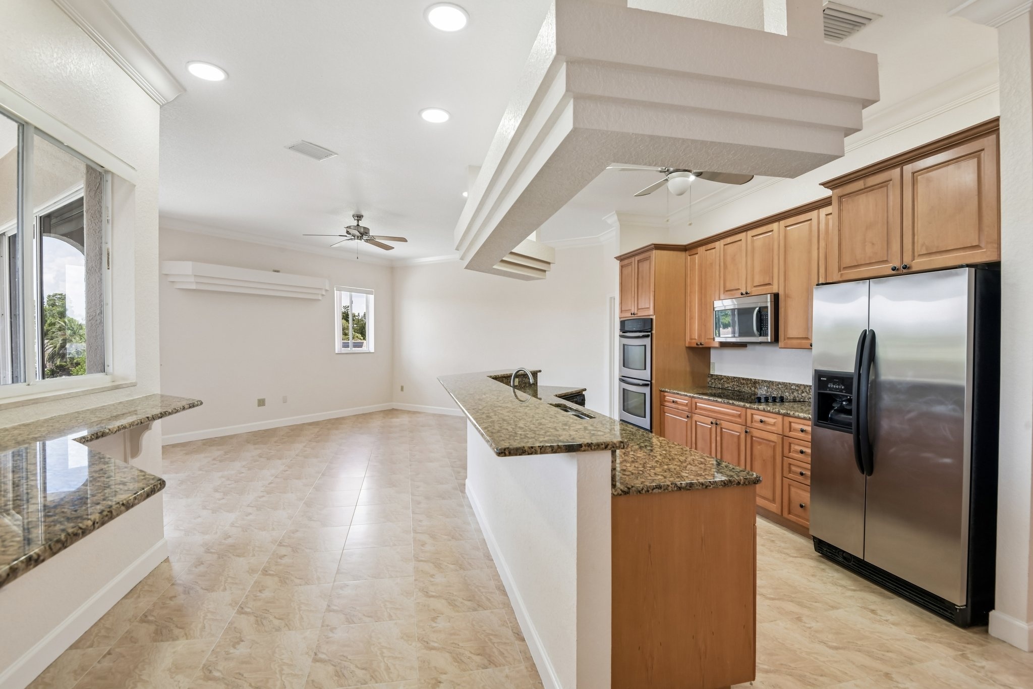 Kitchen with breakfast bar open to the living area in this 4 bedroom Seminole FL home for sale