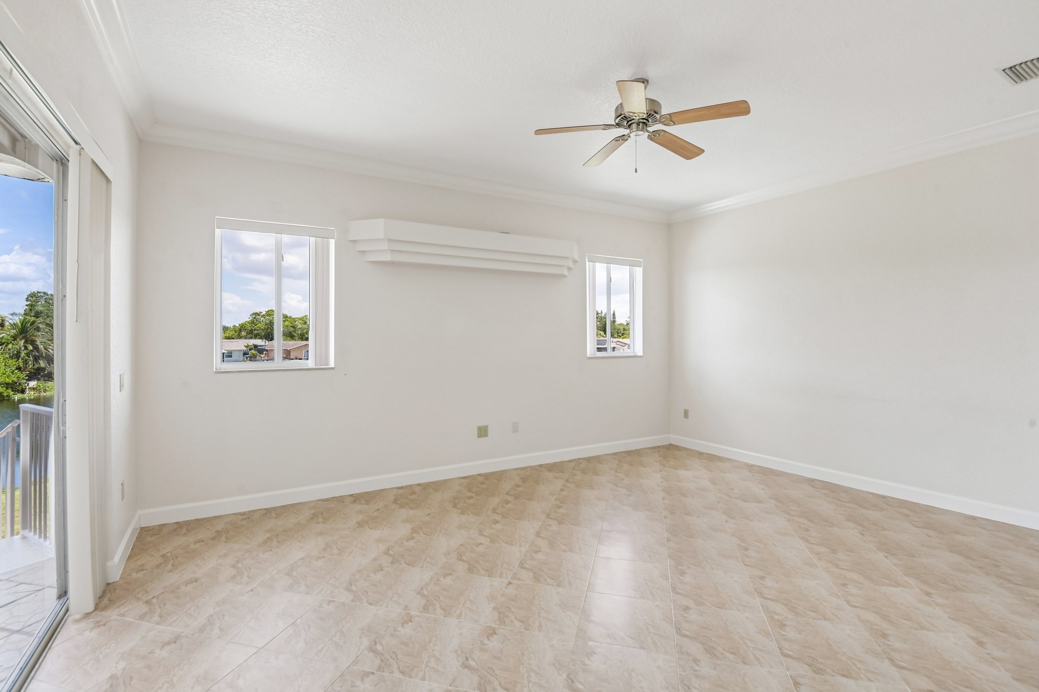 Great room with cathedral ceiling and ceiling fan in this custom-built Seminole FL waterfront estate
