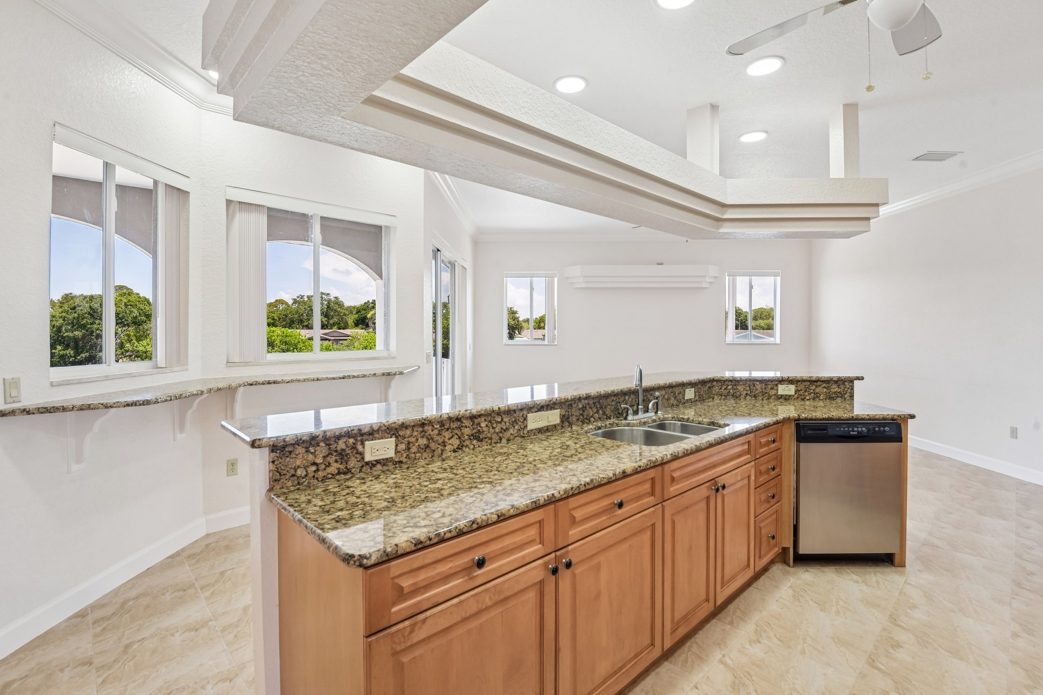 Kitchen island with granite counters and tray ceiling overlooking the water, Seminole FL 33777