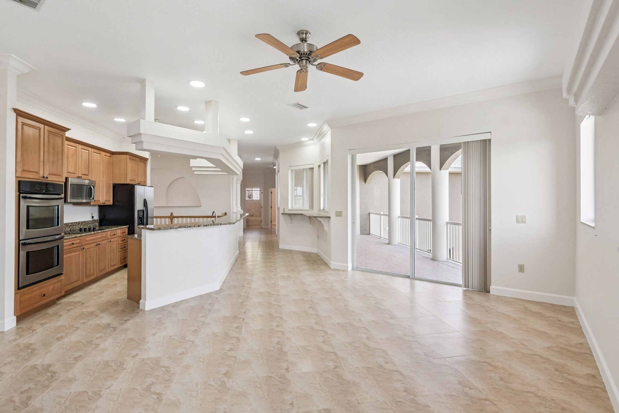 Kitchen with double oven opening to the hallway at 8335 Cheyenne Dr, Seminole FL 33777