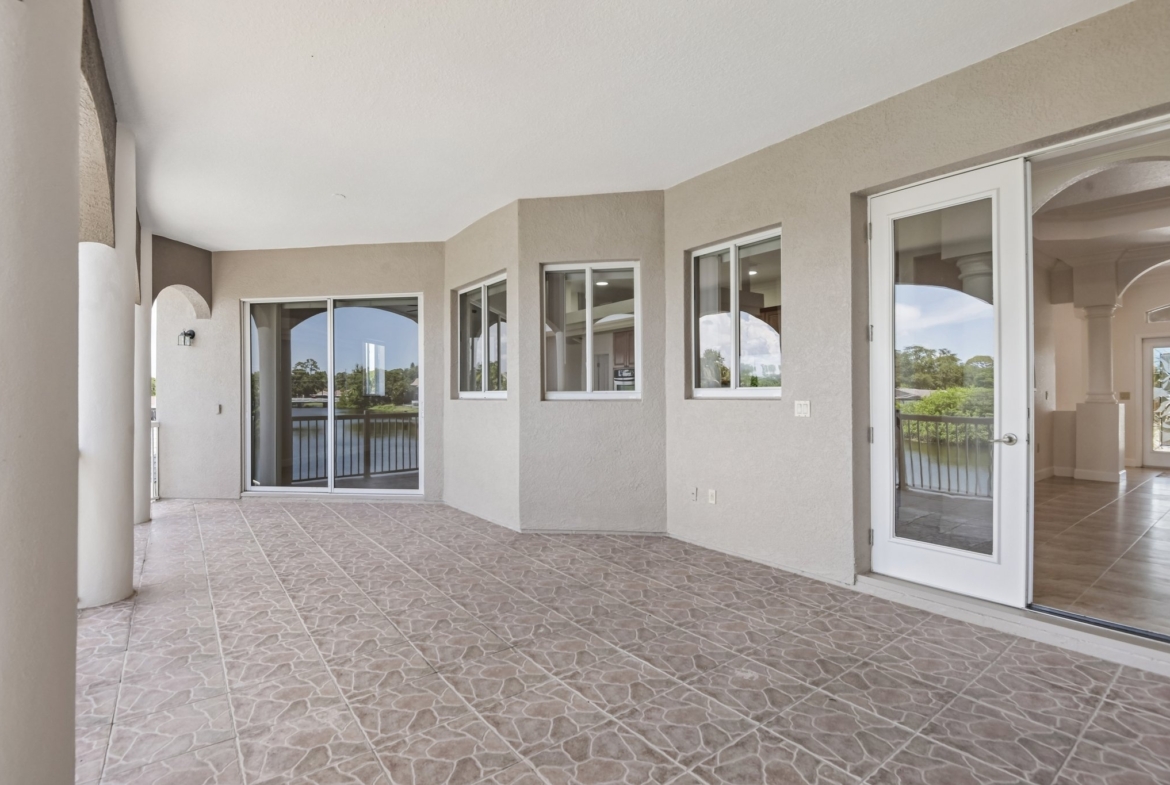 Wall of windows and sliders framing the canal view in this Seminole FL waterfront home