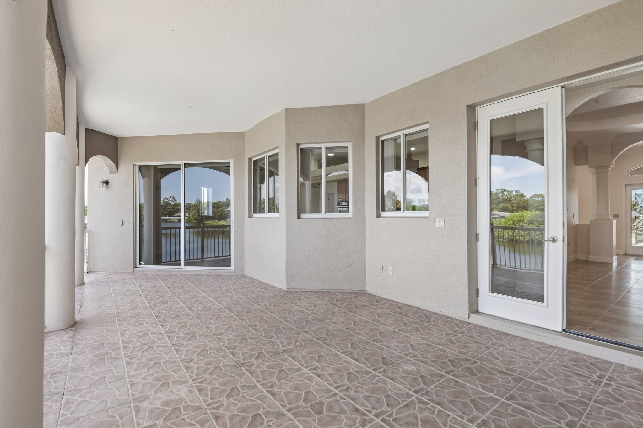 Wall of windows and sliders framing the canal view in this Seminole FL waterfront home