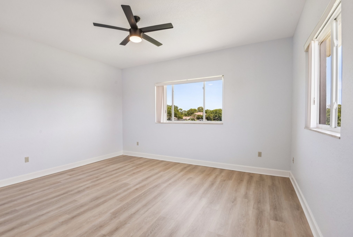 Bedroom with ceiling fan and natural light in this 4 bedroom Seminole FL 33777 home for sale