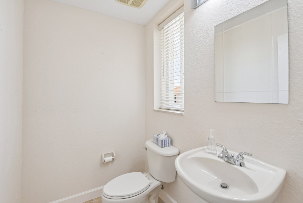 Half bath powder room at 8335 Cheyenne Dr, a 4 bed 3.5 bath home in Seminole FL 33777
