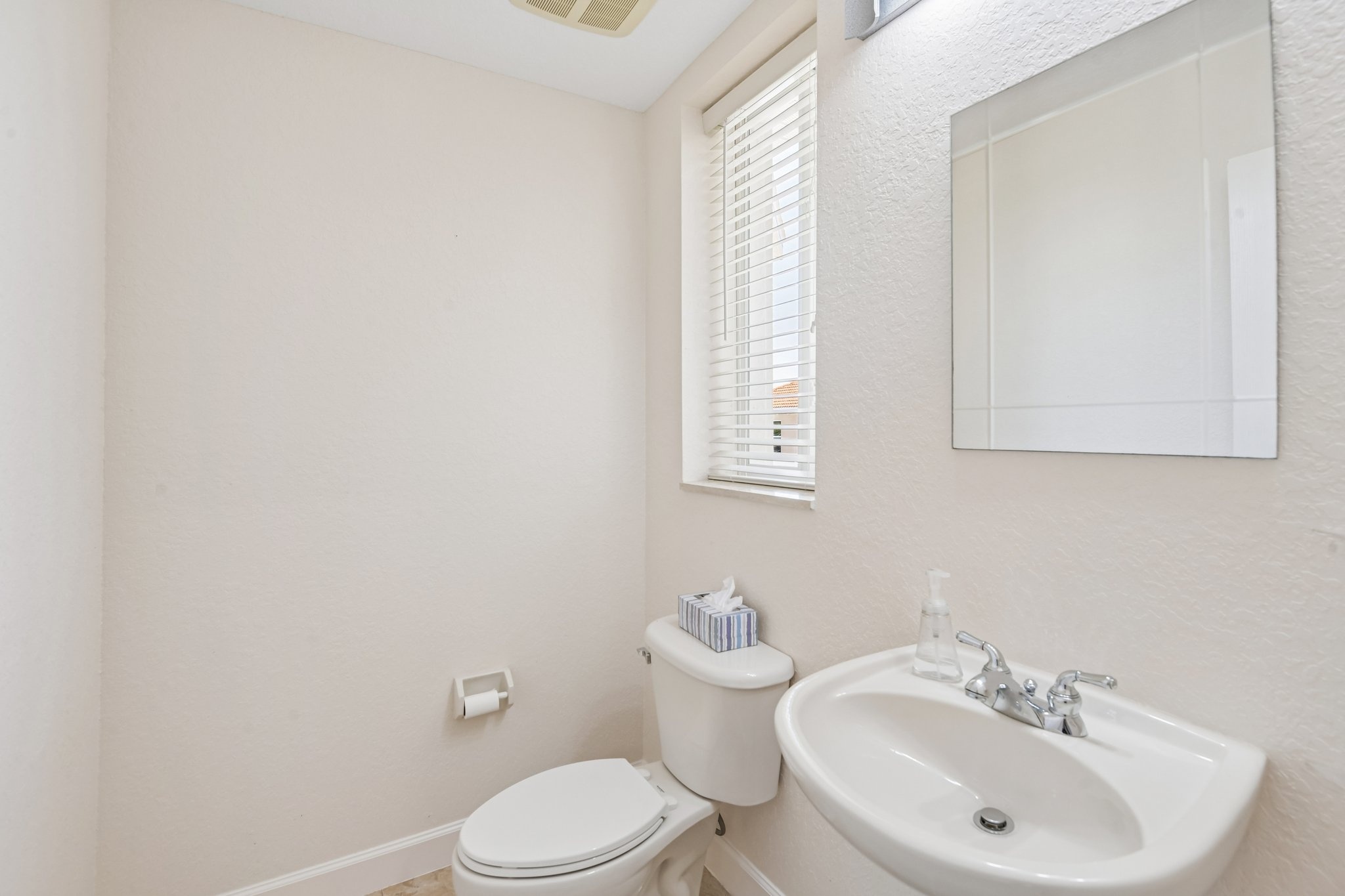 Half bath powder room at 8335 Cheyenne Dr, a 4 bed 3.5 bath home in Seminole FL 33777