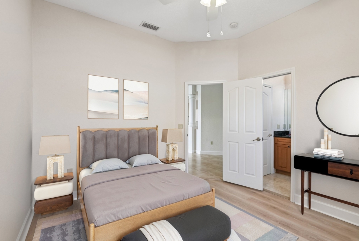 Virtually staged primary suite with sitting area in this Seminole FL waterfront home for sale
