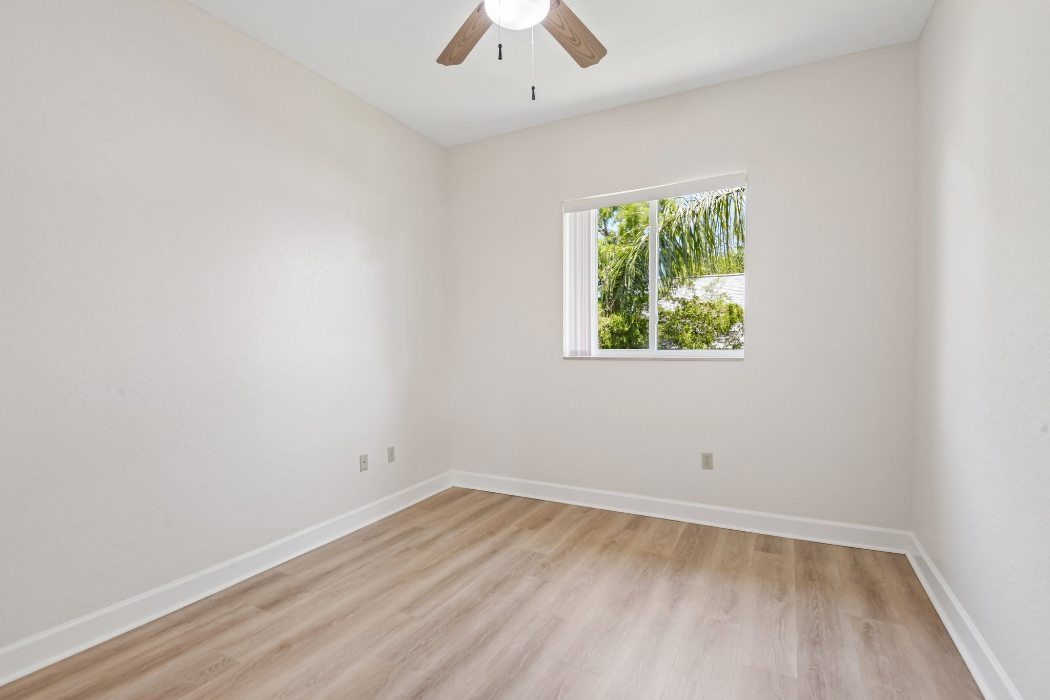 Fourth bedroom with ceiling fan and laminate flooring in this Seminole FL home for sale