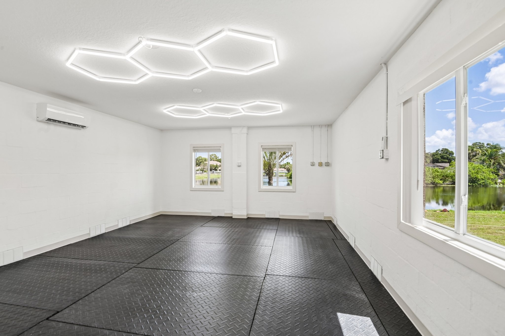 Lower level home gym with rubber flooring and water views at 8335 Cheyenne Dr, Seminole FL