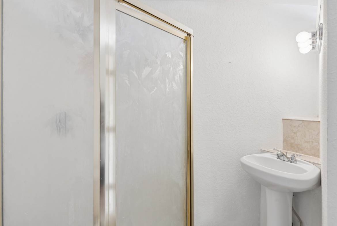 Lower level bathroom with walk-in shower at 8335 Cheyenne Dr, Seminole FL 33777