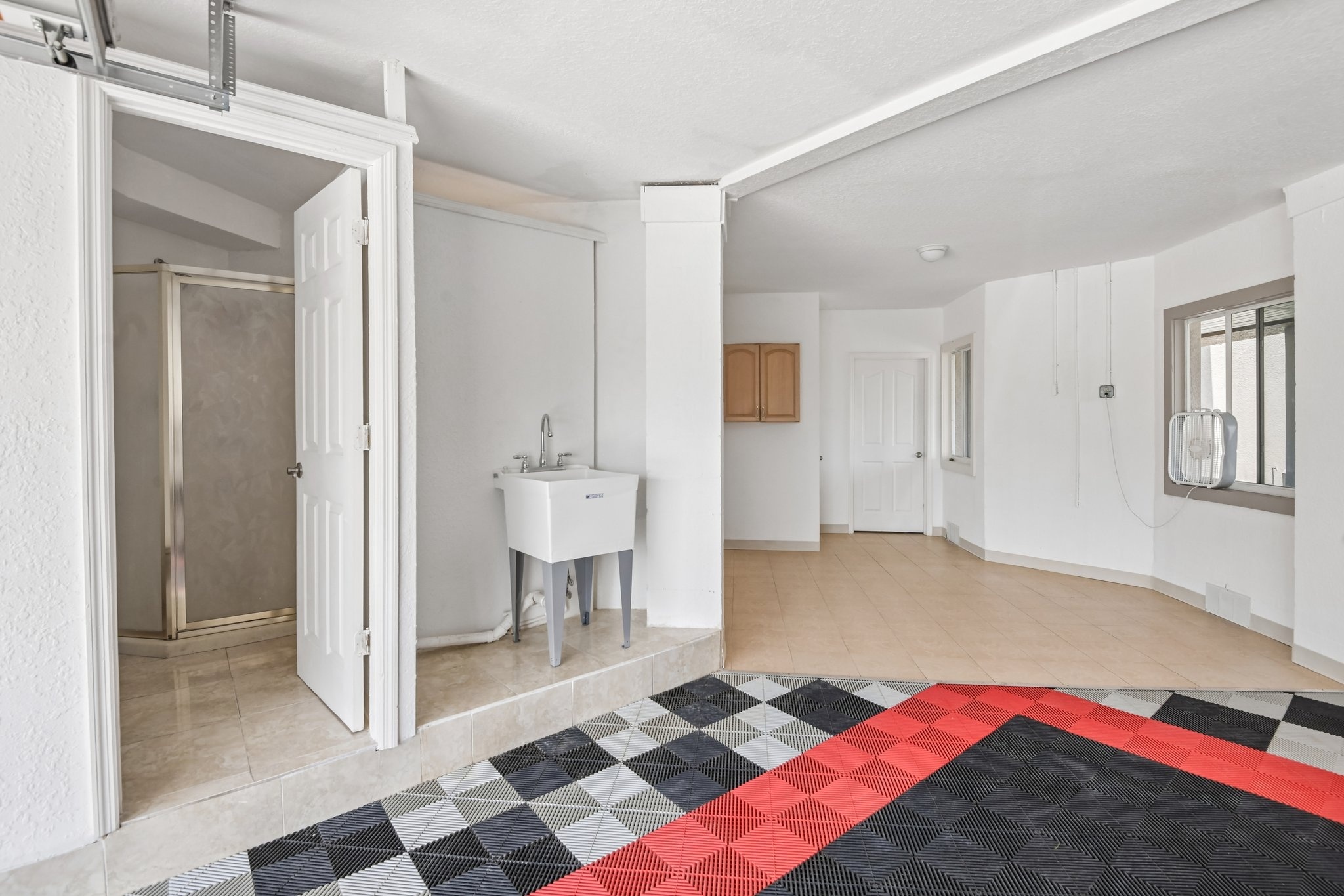 Lower level workshop and utility area with checkered flooring in this Seminole FL home
