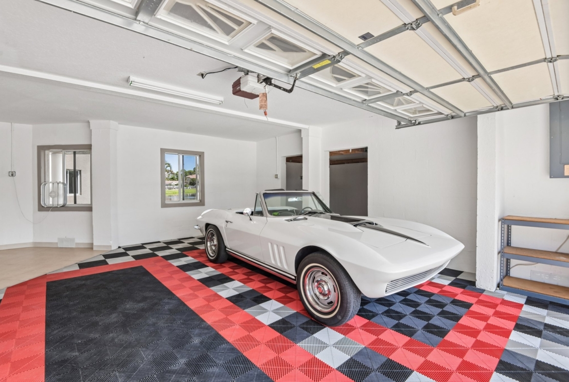 Oversized 3-car side-entry garage with workshop space at 8335 Cheyenne Dr, Seminole FL