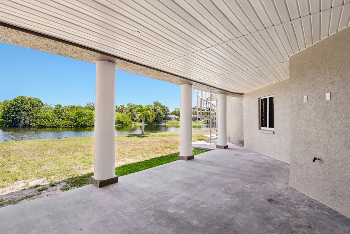 Covered lower patio overlooking the freshwater canal at 8335 Cheyenne Dr, Seminole FL
