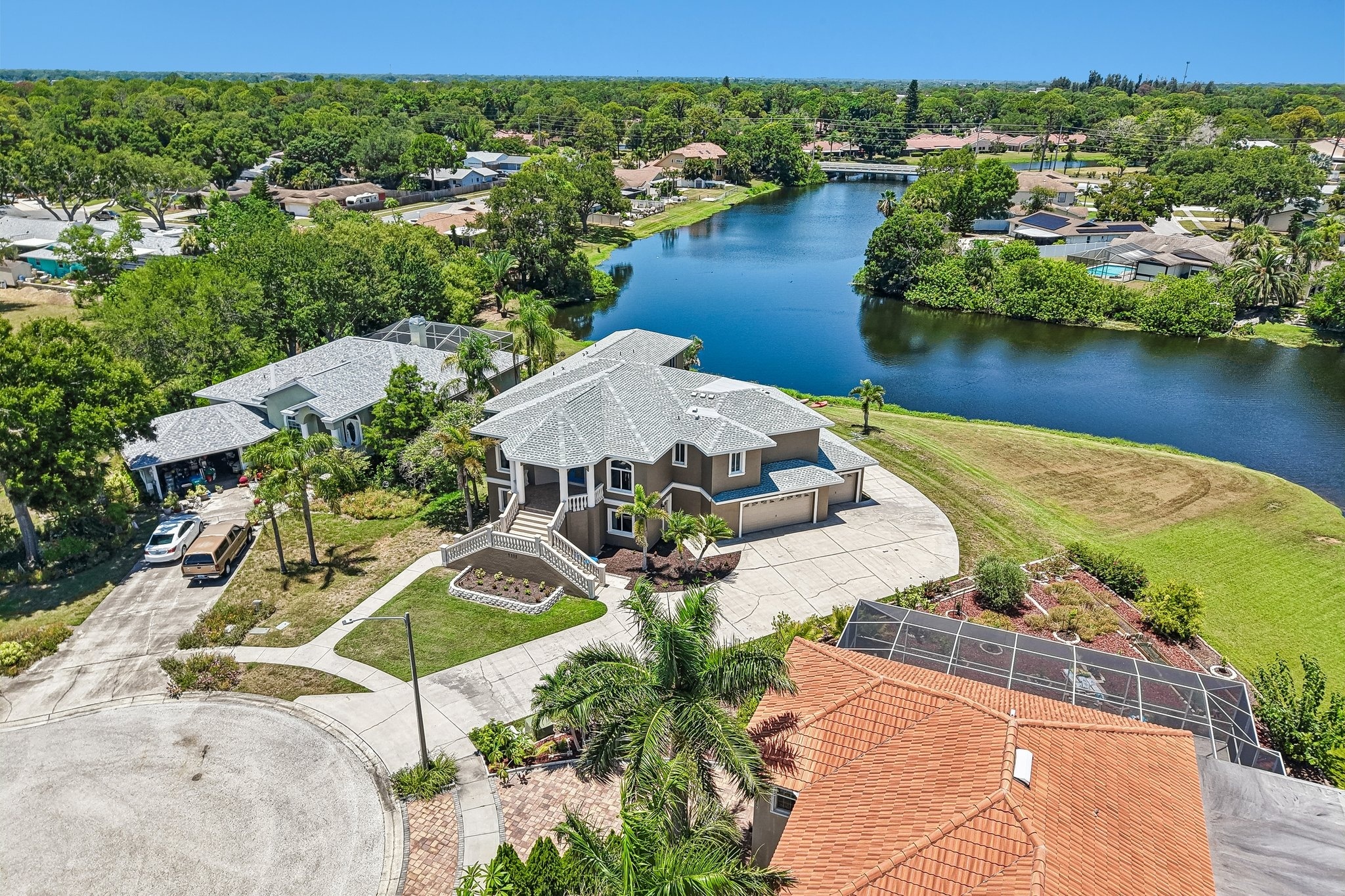 Aerial view of 8335 Cheyenne Dr showing the home, canal and Lake Seminole Park Trails, Seminole FL